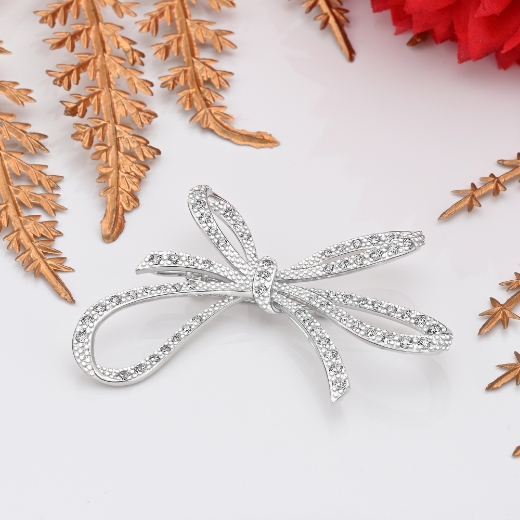 large rhodium plated bow brooch